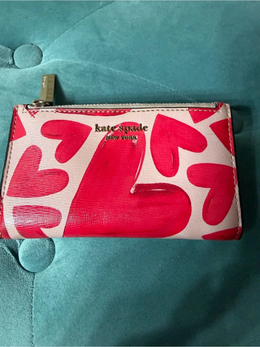kate spade New York pink wallet with bold red heart print and gold logo